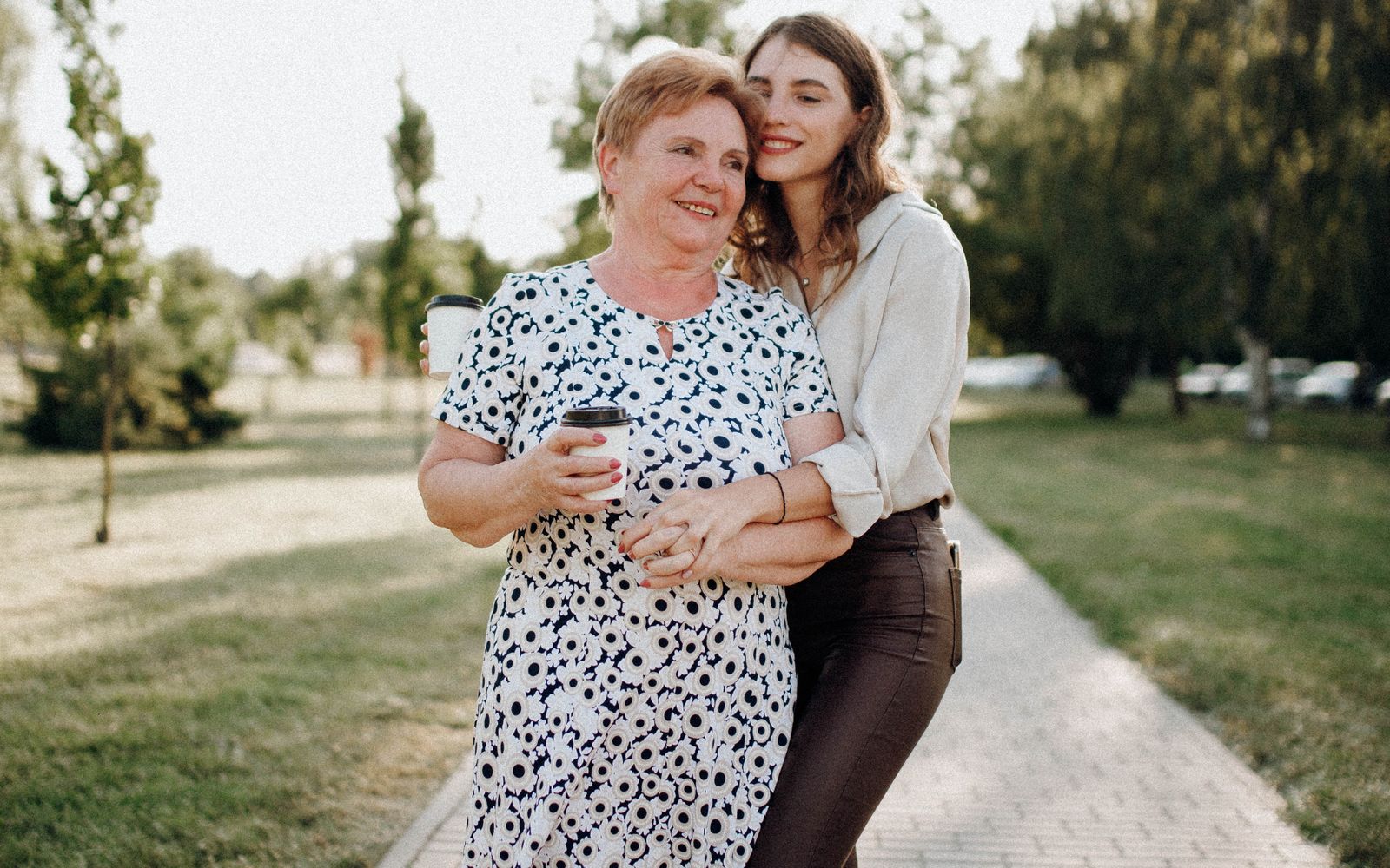 Adult caregiver sharing a tender, unhurried moment with an elderly parent