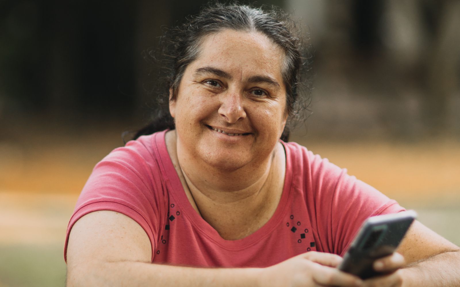 A person calmly and confidently holding a smartphone